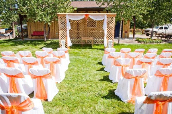This bride chose and orange organza sheer sash to soften the color for he gorgeous outdoor wedding!